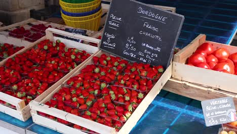 fresh strawberries and tomatoes displayed at market