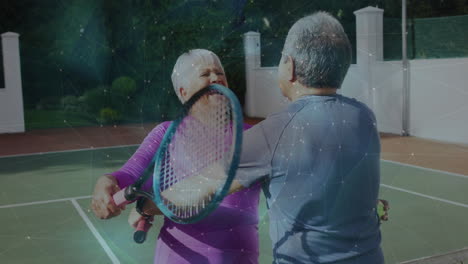 senior couple playing tennis with rackets on court, with animated sports technology chart floating
