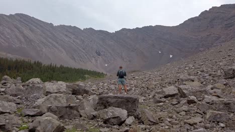 hiker checking map in the valley approached from the back rockies kananaskis alberta canada