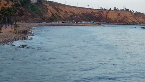 top down birds eye aerial view of the waves crashing on a rocky southern california beach