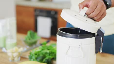 Fit-african-american-man-cooking,-preparing-healthy-green-smoothie