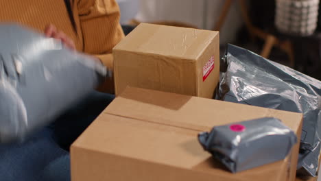 woman unboxing packages at home