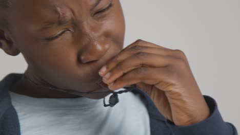 studio shot of boy on asd spectrum using sensory chew toy to calm himself and de-escalate anxiety 1