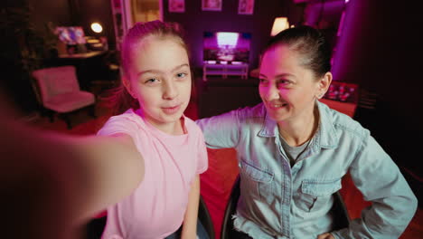 mom learning trending choreography from influencer daughter in apartment illuminated by pink neon