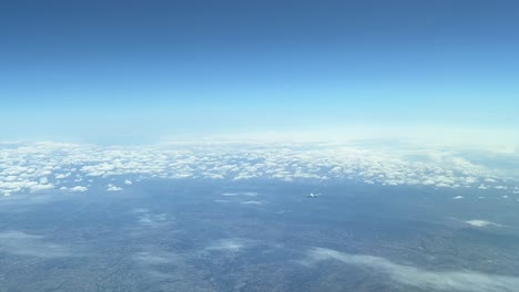 Aerial-view-of-the-crossing-of-two-jets-flying-opposite-direction-shot-from-a-jet-cabin