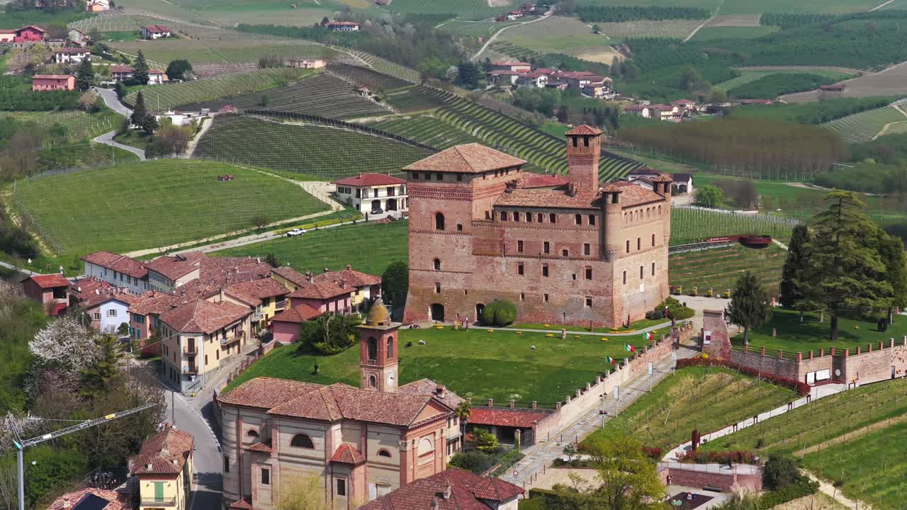 Drone landscape view of historic Grinzone Cavour castle on sunny day, Italian countryside