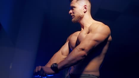 handsome athletic sportsman. strong muscular bodybuilder athlete man posing at gym