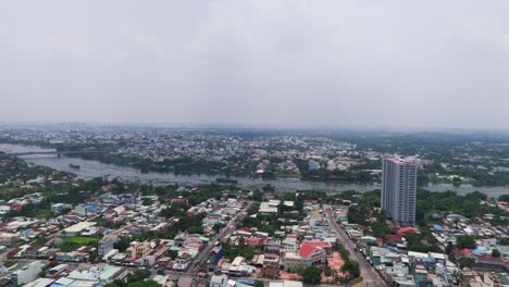aerial view dolly of the city and the river in binh duong.