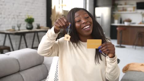 happy young woman holds key of new home