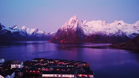 picturesque landscape of small town on seashore surrounded by massive mountains