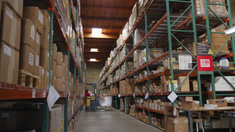 forklift lifting pallet for storing on tall rack in the warehouse