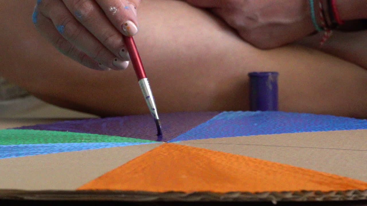 Caucasian woman preparing a circular cardboard, in order to make a wheel of fortune, close up, tight shot 120fps
