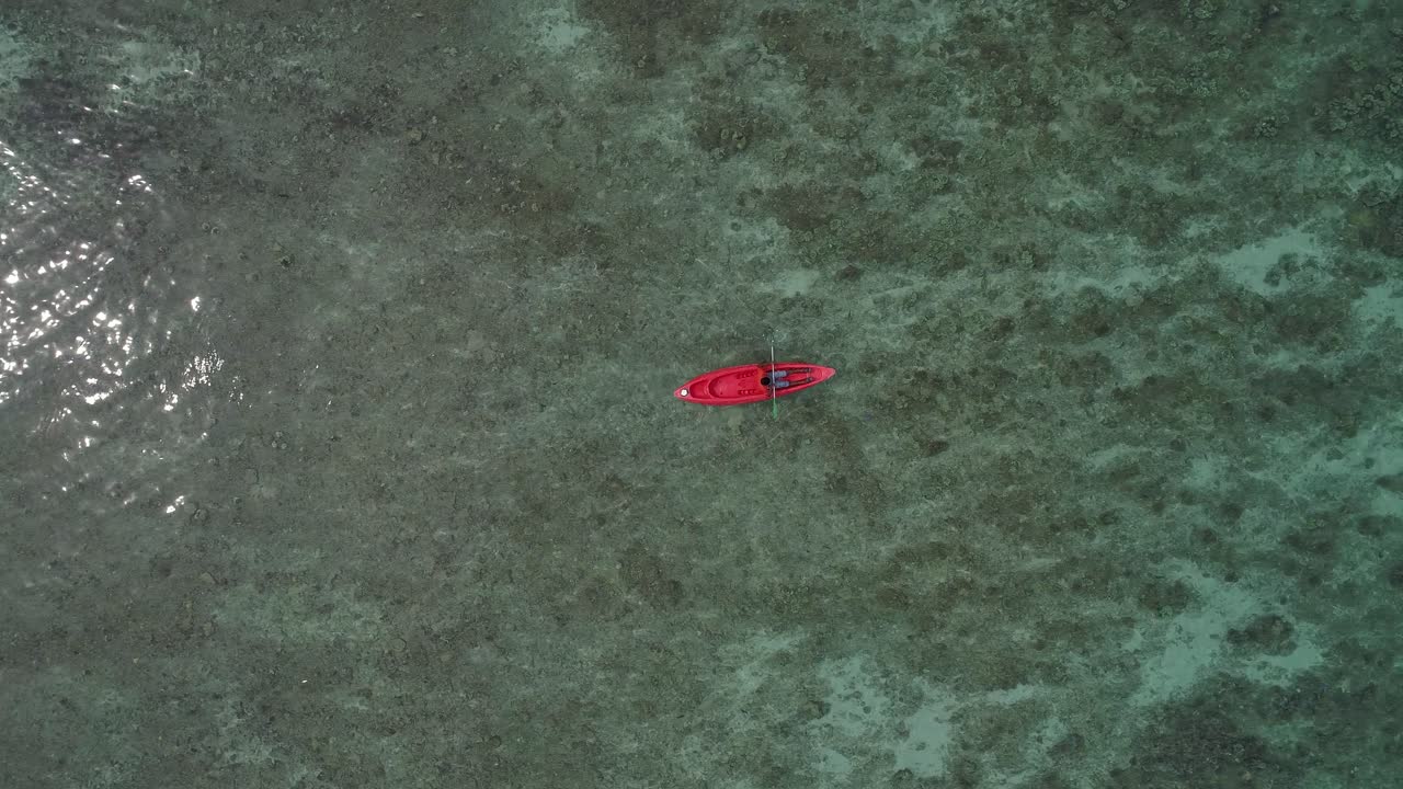 Aerial View of a Red Kayak in Calm Water