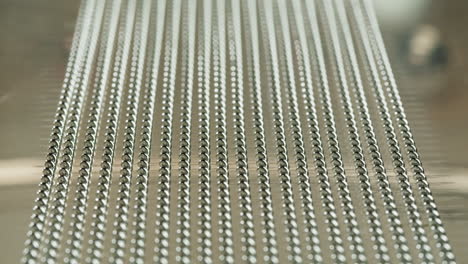 rows of small metal spheres on a metallic surface