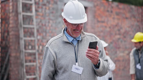 construction worker using a phone at a construction site