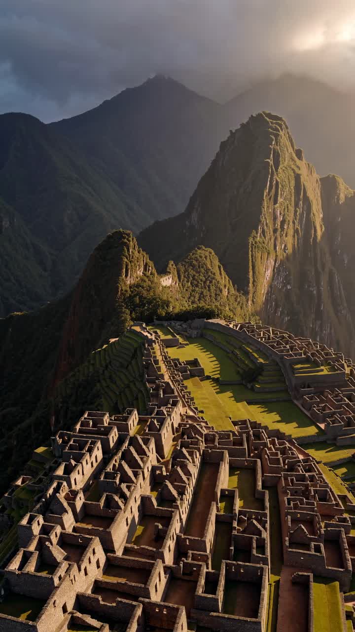Aerial view of ancient ruins nestled in lush mountains, capturing the dramatic landscape