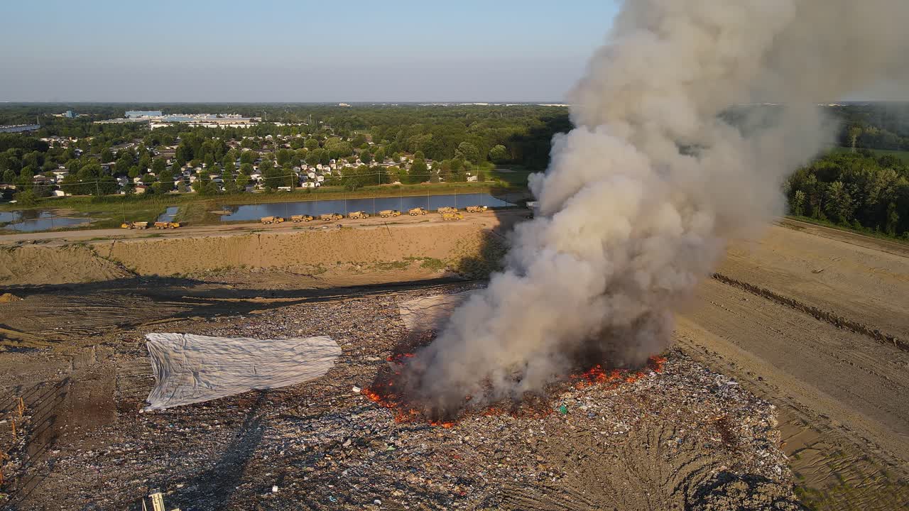 Woodland Meadows Landfill burning with smoke rising from fire in drone video