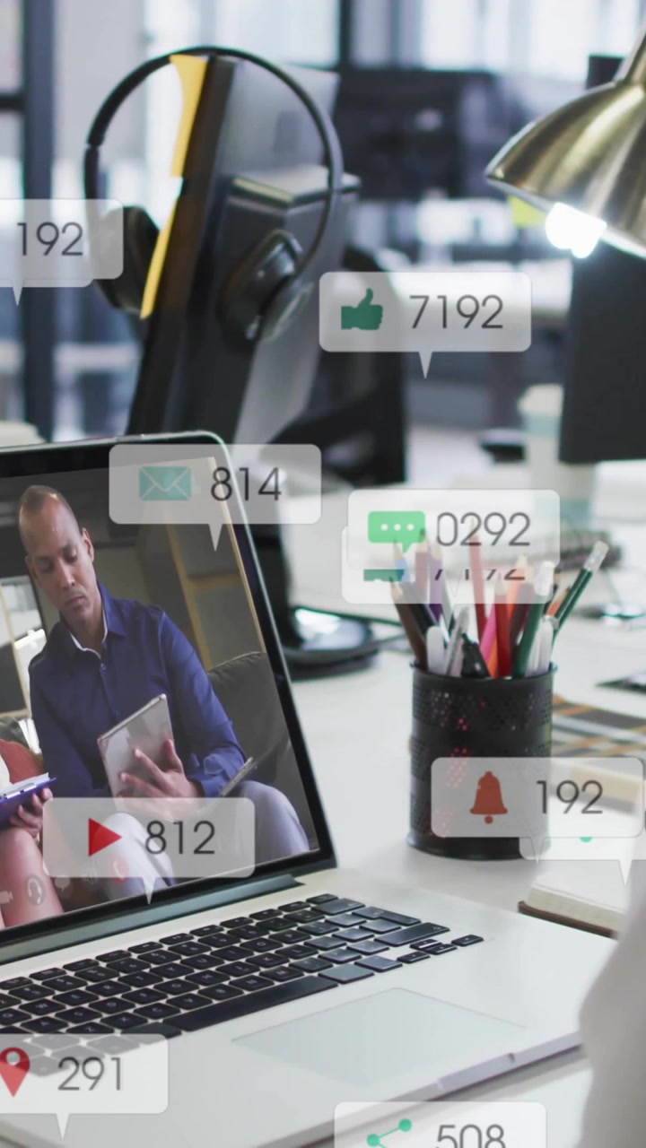 Watching animation video on laptop, person receiving social media notifications