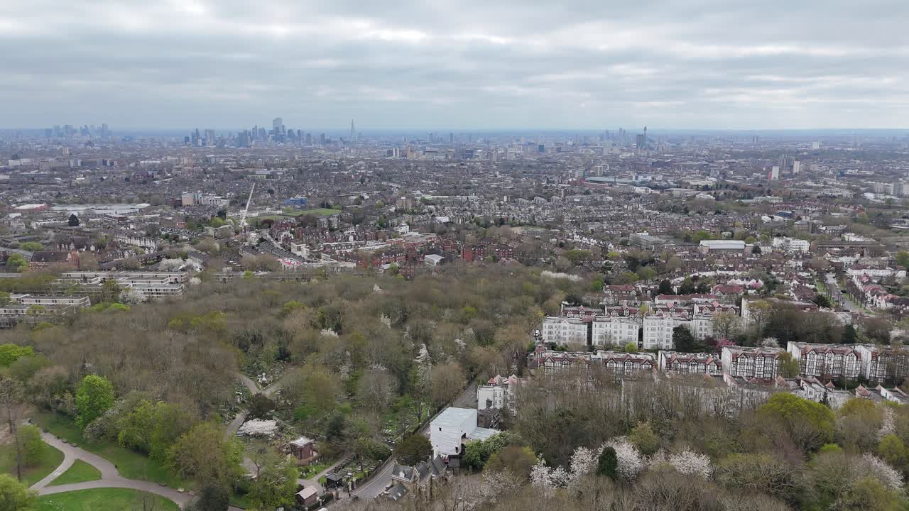 Highgate cemetery London in distance Panning drone aerial