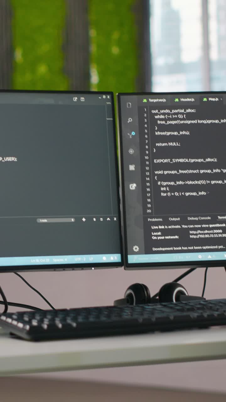Vertical video PC screens on office desk used to design and implement AI algorithms
