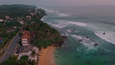 stunning aerial footage capturing the golden hues of sunset over the weligama coastline in sri lanka.