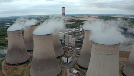 establishing drone shot of coal fired power plant and cooling towers