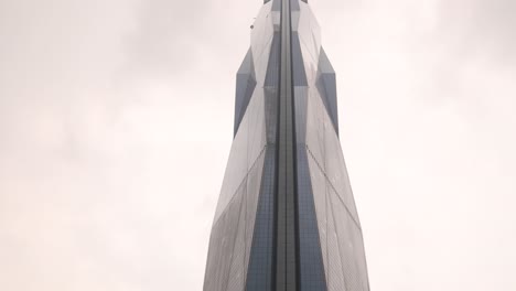 looking up at view of ultra modern merdeka 118 tower, the second tallest building in the world in kuala lumpur, malaysia skyline