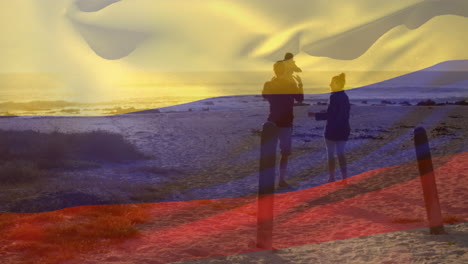 animation of flag of colombia over caucasian parents with child at beach