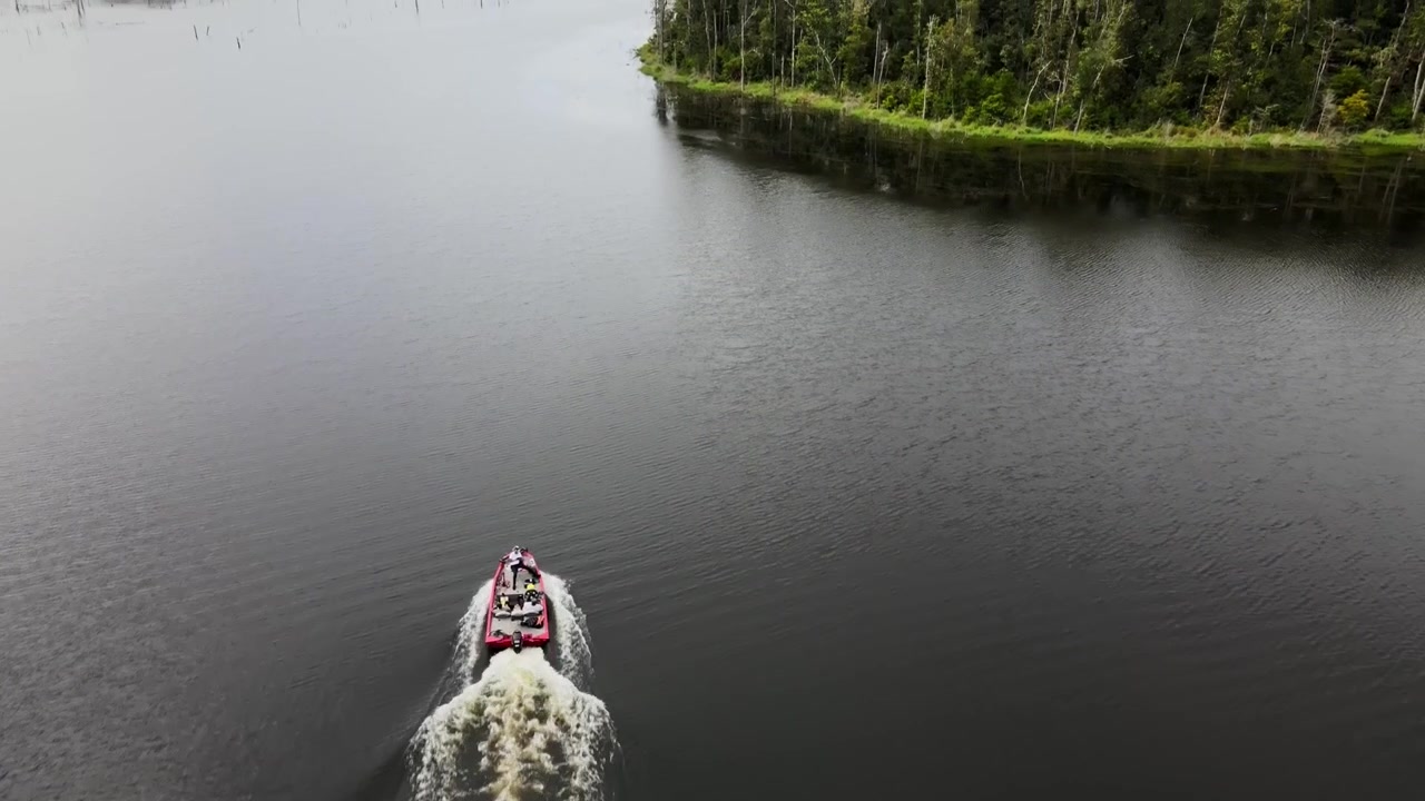 Speedboat Leaving Wake On The Water Surface Of River. - aerial shot