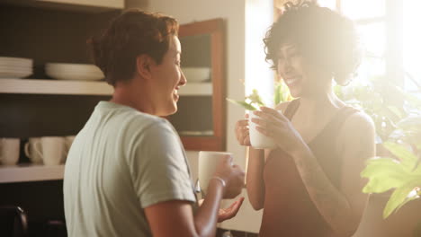 two women having coffee in kitchen