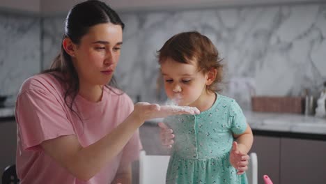 a tender moment: mother and daughter explore the wonders of cooking together with flour in a bright kitchen setting