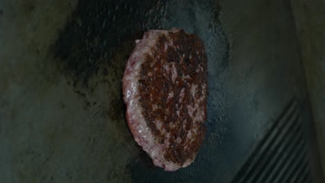 vertical shot of grilling beef meat for hamburger