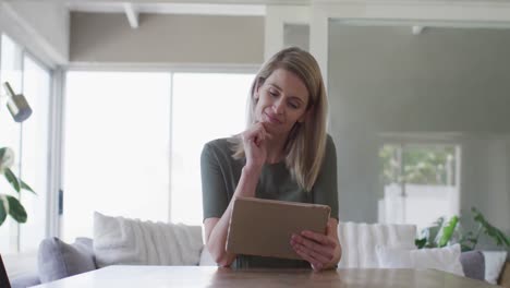 Woman-using-digital-tablet-at-home