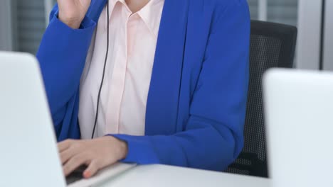 businesswoman wearing headset working actively in office