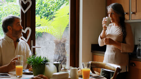 Senior-couple-interacting-with-each-other-while-having-coffee-4k