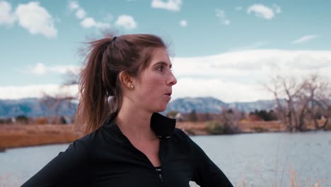 woman enjoying a scenic view of a lake and mountains