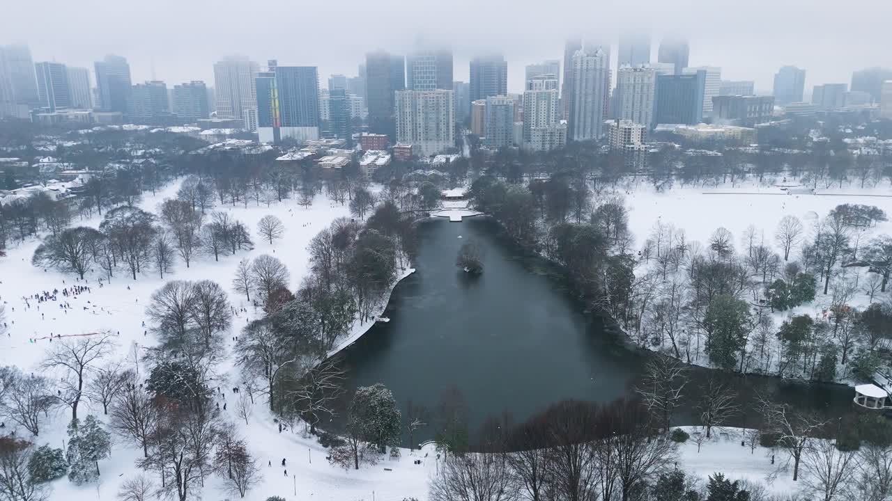 Aerial shot of snow covered Piedmont Park and Midtown in Atlanta, Georgia on January 10th, 2025.
