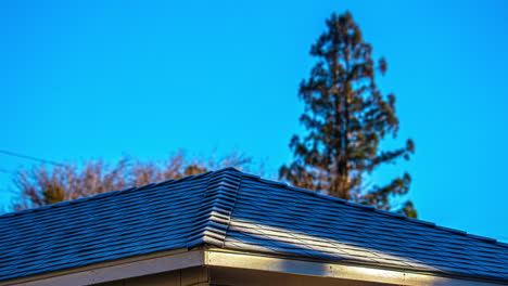 time-lapse of snow and frost melting from a house roof, sunny winter morning