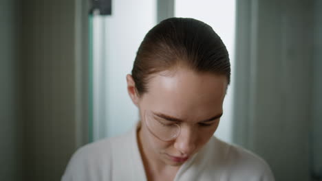 woman applying gel patches under eyes for skincare routine at home portrait