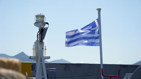greek flag hoisted on the mast, fluttering in the wind