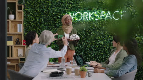 muslim-business-woman-presenting-geodesic-dome-model-in-office-meeting-colleagues-brainstorming-creative-design-solution-discussing-engineering-ideas-in-startup-presentation