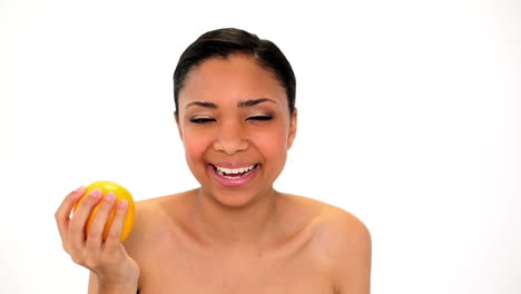 cute laughing woman holding orange