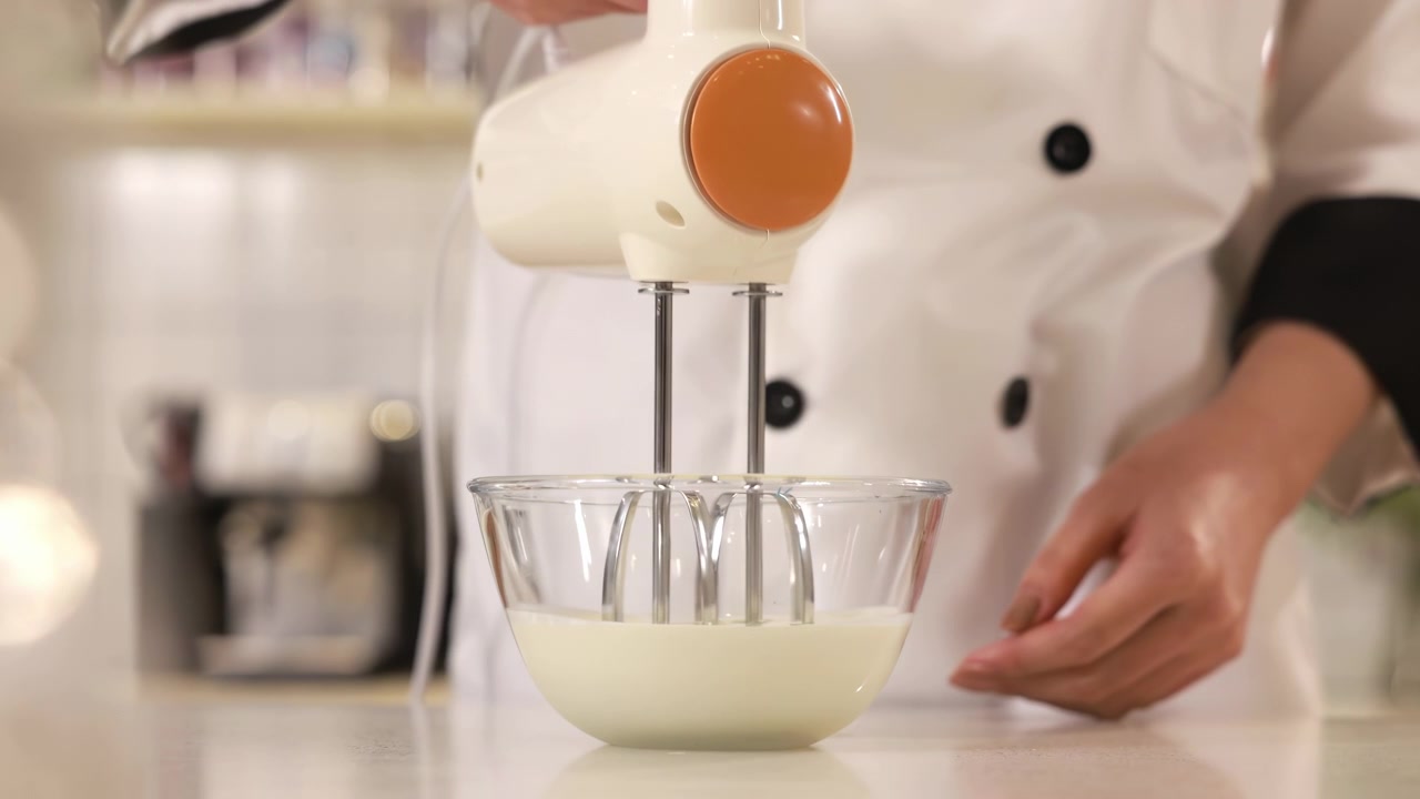 Pastry chef hand cooking process adds sugar and flour in white bowl whipping raw egg whites with butter with electric mixer beats for delicious birthday bakery order, baking, confectionery, culinary