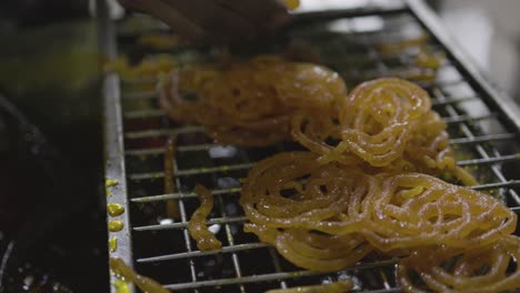 indian traditional sweet jalebi at street shop for sale at evening