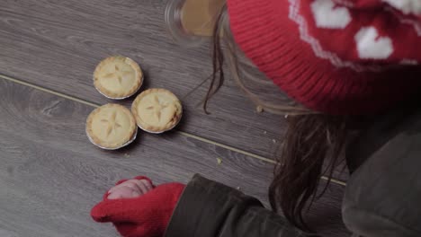 Woman-wearing-winter-hat-and-gloves-grabbing-pies-and-coffee-1