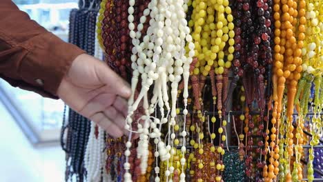 close up shot of man looking at beads