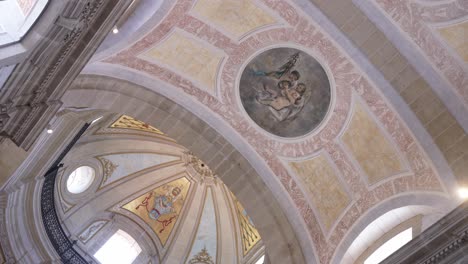 painted ceiling details and soft light inside the bom jesus church interior in braga portugal