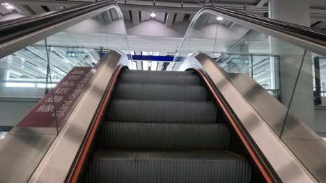 ascending escalator in a modern airport terminal