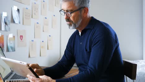 man using digital tablet at home 4k