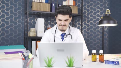 A-doctor-looking-at-the-camera-and-smiling.-In-his-office.